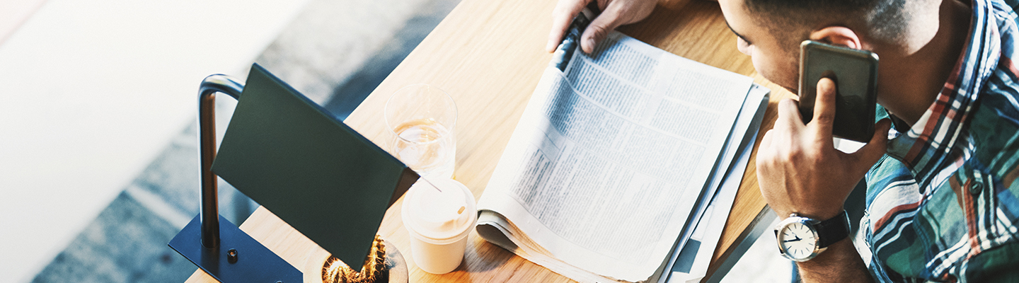 photo of a man reading news